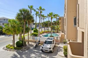 an aerial view of a parking lot with a car and palm trees at Sunset Terrace 109 in Bradenton Beach