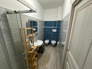 a bathroom with a sink and two toilets in it at SEASIDE Bed and Breakfast in Praia a Mare +73 photos