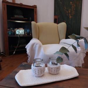 a table with two baskets and a chair at LAS CASUARINAS CABAÑA Spa in Carmen de Areco