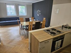 a kitchen and dining room with a table and a stove at GardenLoft no1 in Vienna