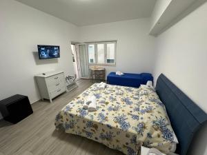 a bedroom with a bed and a tv in it at SEASIDE Bed and Breakfast in Praia a Mare
