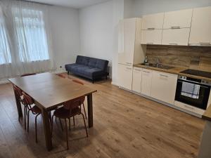 a kitchen and dining room with a table and a couch at GardenLoft no2 in Vienna +4 photos