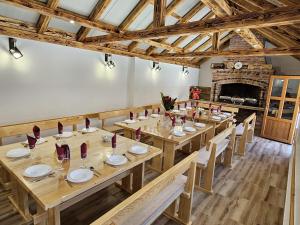 a large dining room with wooden tables and chairs at Cherry Berry Apartmani in Eminovci