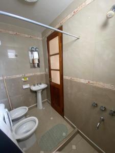 a bathroom with a toilet and a shower and a sink at Casa en centro salteño in Salta +19 photos
