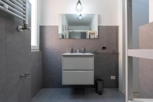 a bathroom with a sink and a mirror at Ciampino-Roma - Modern Apartment-Airport & Station in Ciampino +32 photos