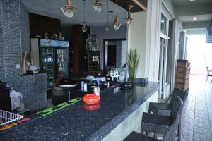a bar in a restaurant with black counter and chairs at Travel Inn Hotel Simpson Bay in Simpson Bay