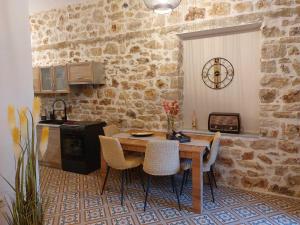 a kitchen with a table and chairs in a room at Stone-built Villa Nesseris 80 m2 in Preveza