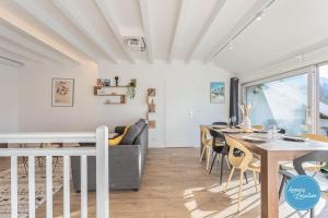 a dining room and living room with a table and chairs at LEscapade du Col Cozy 2-Bedroom Apartment in Bluffy