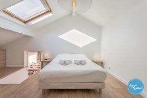 a bedroom with a bed with two stuffed animals on it at LEscapade du Col Cozy 2-Bedroom Apartment in Bluffy +12 photos