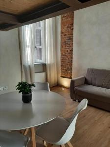 a living room with a table and chairs and a couch at Il Garibaldi in Savigliano