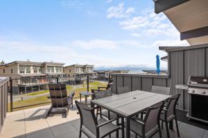 a patio with a table and chairs on a balcony at Ocean View Townhouse #27 in Oyster Bay