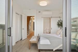 a bedroom with a bed and a sliding glass door at Ocean View Townhouse #27 in Oyster Bay