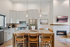 a kitchen with a table and chairs and a fireplace at Ocean View Townhouse #27 in Oyster Bay