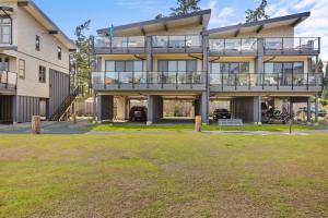 an apartment building with a lawn in front of it at Ocean View Townhouse #27 in Oyster Bay