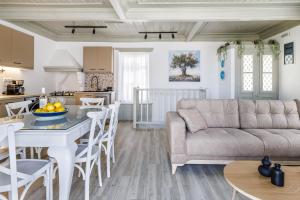 a living room with a couch and a table at Amorama Suites - Authentic Village Stay in Glossa in Glossa