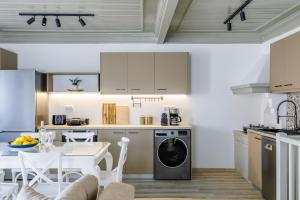 a kitchen and dining room with a washer and dryer at Amorama Suites - Authentic Village Stay in Glossa in Glossa +29 photos
