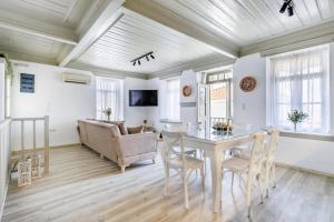 a living room with a table and a couch at Amorama Suites - Authentic Village Stay in Glossa in Glossa