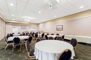 a conference room with tables and chairs and a whiteboard at Best Western Miners Inn Yreka in Yreka