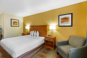 a hotel room with a bed and a chair at Best Western Kiva Inn in Fort Collins +24 photos
