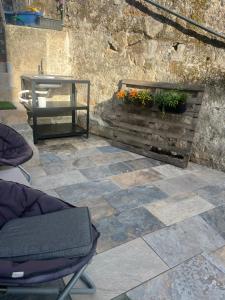 a patio with a bench and a table and flowers at Friend's House in Maia +8 photos