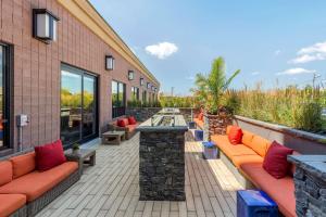 a patio with couches and tables on a brick building at Comfort Inn & Suites Logan International Airport in Revere