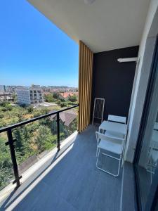 a balcony with a bench and a view of the city at Bulldog Studio in Năvodari