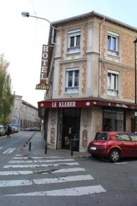 a red car parked in front of a building at Le Kleber in Montreuil