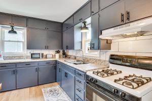 a kitchen with blue cabinets and a stove top oven at Peaceful Robinson Home with Yard, Near Golf Courses! in Robinson