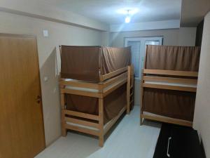 a room with two bunk beds and a door at Historia Hostel in Skopje