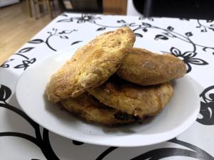 three biscuits on a plate on a table at Historia Hostel in Skopje