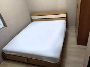 a small bed in a small room at Historia Hostel in Skopje