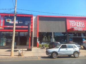 a car parked in front of a store at Teixeira in Olímpia