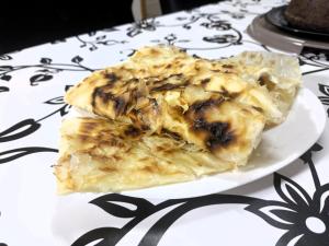 two slices of food on a plate on a table at Historia Hostel in Skopje