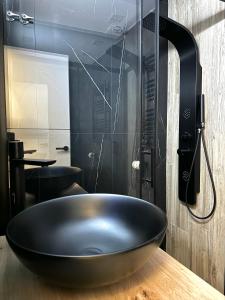 a black bowl sink on a counter in a bathroom at Kilometro 22 Luxury in Padrón