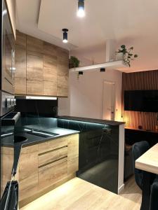 a kitchen with wooden cabinets and a black counter top at Kilometro 22 Luxury in Padrón +9 photos
