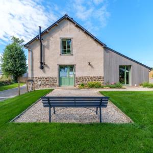 a bench sitting in front of a house at Grange moderne près de Rennes avec jolie vue ! in Gévezé