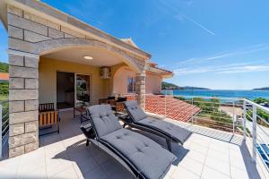 a patio with chairs and a view of the water at Apartments by the sea Prizba, Korcula - 22068 in Blato