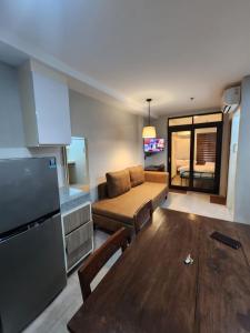 a living room with a couch and a table at 2F Vivere Condo - Govantes Properties in Vigan