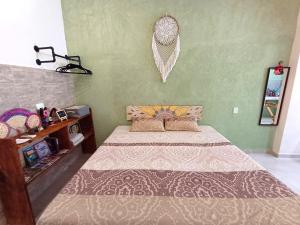 a bedroom with a bed and a wall at Casa Candelita in Valladolid