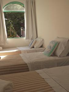 Postel nebo postele na pokoji v ubytování Vila Rita Hostel Arraial d'Ajuda