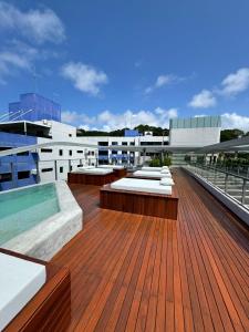 eine Dachterrasse mit einem Whirlpool auf einem Gebäude in der Unterkunft Setai Yacth, Flat para até 03 pessoas a beira mar do Cabo Branco in João Pessoa