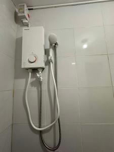 a shower in a bathroom with a hose at Entire Townhouse - SANTO TOMAS BATANGAS in Santo Tomas