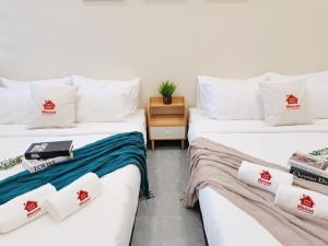two beds sitting next to each other in a room at 20Pax Town Centre Corner Lot, Near SKT Ballroom in Muar