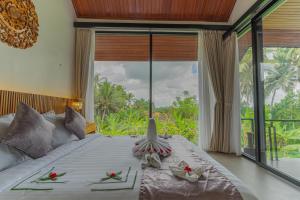 Postel nebo postele na pokoji v ubytování Abian Ubud View + 37 fotografií