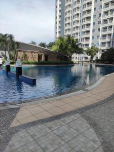 a large pool of water in a city with tall buildings at Pakuwon Mall Orchard ComFy New Apartemen with Wifi in Surabaya