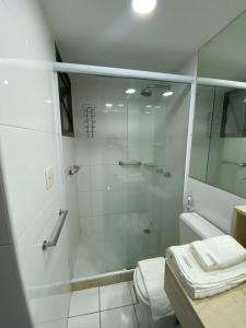 a bathroom with a shower with a glass door at Botafogo Suites in Rio de Janeiro