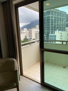 a room with a view of a balcony with a window at Botafogo Suites in Rio de Janeiro +27 photos