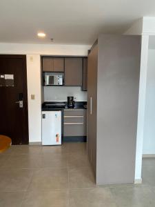 a kitchen with a white refrigerator and a stove at Botafogo Suites in Rio de Janeiro