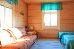 a living room with a couch and a window at Koskikievari in Lappajärvi