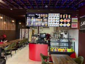 a fast food restaurant with a counter and tables at Grand Plaza Hotel in Tumon